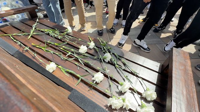 Students at Dr. Howard Fuller Collegiate Academy marched to Victory Over Violence Park and laid a flower down in honor of those impacted by violence. (Abbey Taylor/Spectrum News 1)