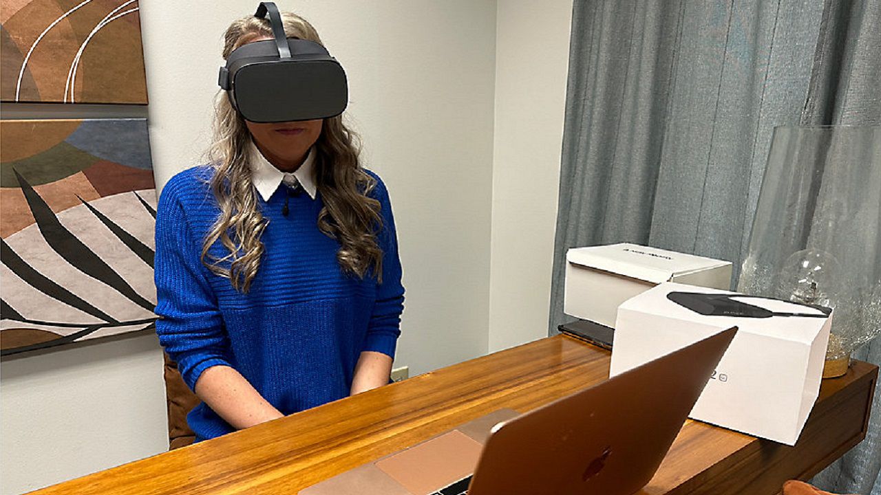 Brandie Terifaj wears virtual reality headset used during therapy