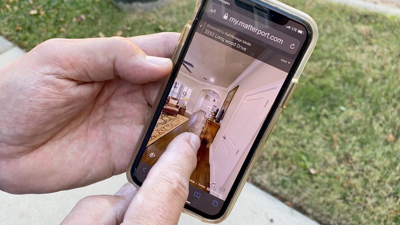 Realtor Tad Miller displays a home listing's virtual tour in this image from November 2020. (Lupe Zapata/Spectrum News 1)