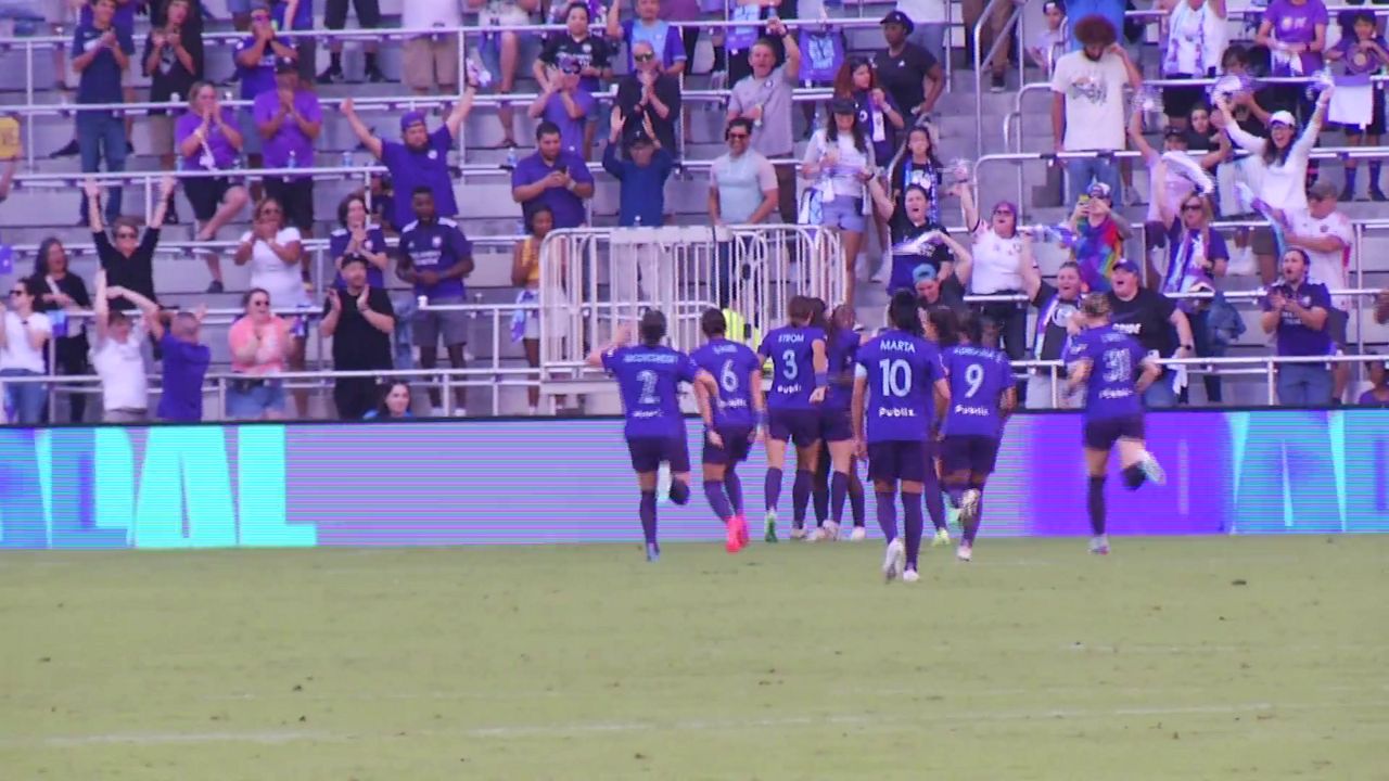 Orlando Pride teammates gather around Barbra Banda after she scored a go-ahead goal. (Spectrum News/Nick Allen)