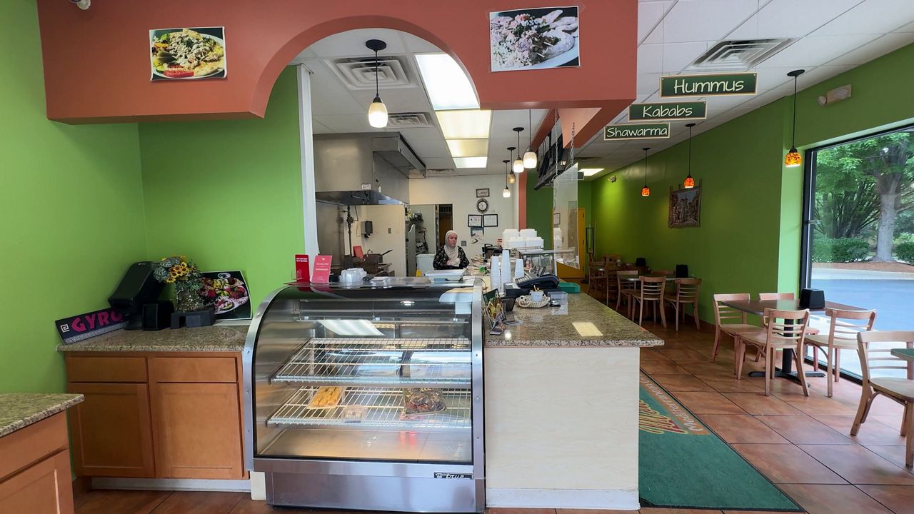 Mona Cheko owns Mona Pita Mediterranean Grill, a restaurant down the street from where the protest is scheduled to take place. (Spectrum News 1)