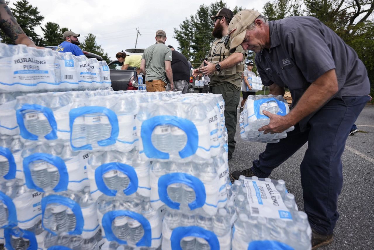 Volunteers stage water for people in the aftermath of Hurricane Helene, Monday, Sept. 30, 2024, in Asheville, N.C. (AP Photo/Mike Stewart)