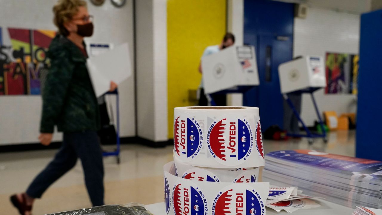 Voters mark their ballots at Frank McCourt High School in Manhattan on Tuesday, June 22, 2021. (AP Photo/Richard Drew)