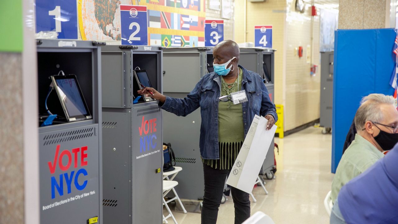 A poll worker prints a ballot from a Board of Elections printing machine at an early voting polling site in New York City on Tuesday. (AP Photo/Ted Shaffrey)