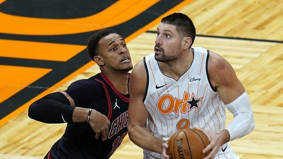 Orlando Magic center Nikola Vucevic, right, looks for a shot against Chicago Bulls center Daniel Gafford during the second half of an NBA basketball game Friday, Feb. 5, 2021, in Orlando, Fla. (AP Photo/John Raoux)