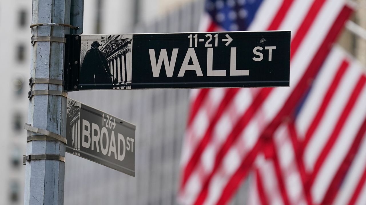 A street sign is seen in front of the New York Stock Exchange in New York, Tuesday, June 14, 2022. (AP Photo/Seth Wenig)