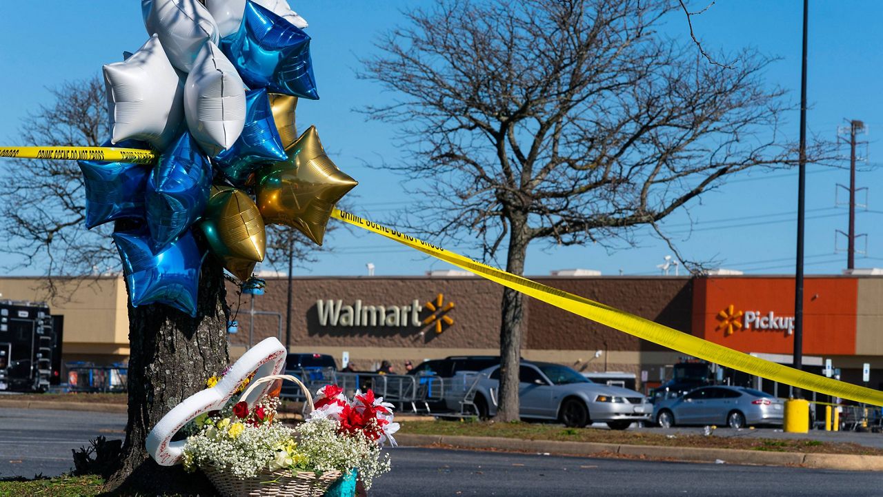 Flowers and balloons have been placed near the scene of a mass shooting at a Walmart on Wednesday in Chesapeake, Va. (AP Photo/Alex Brandon)