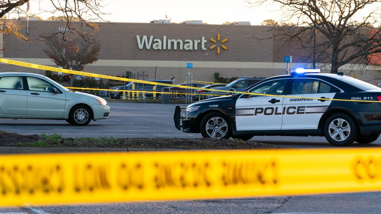Law enforcement officers work the scene of a mass shooting Wednesday at a Walmart in Chesapeake, Va. (AP Photo/Alex Brandon) 