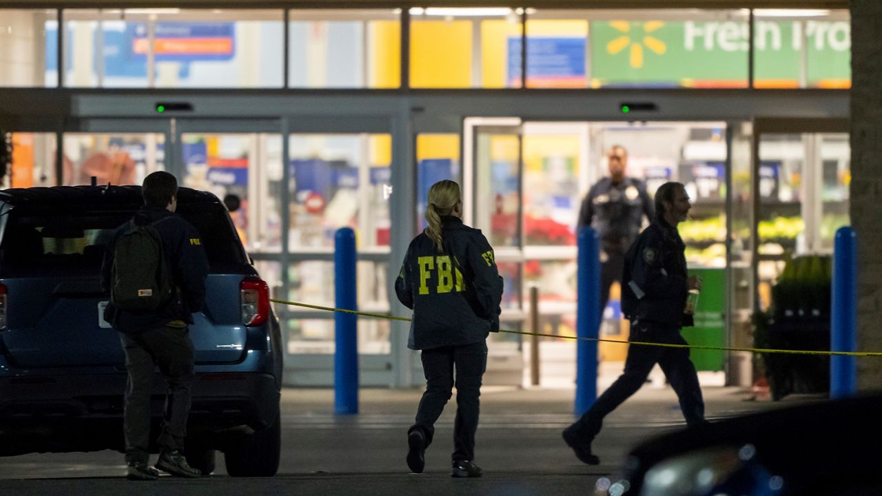 Police and FBI investigate the scene at the Virginia Walmart late Tuesday after a Walmart supervisor opened fire on employees. (AP Photo)
