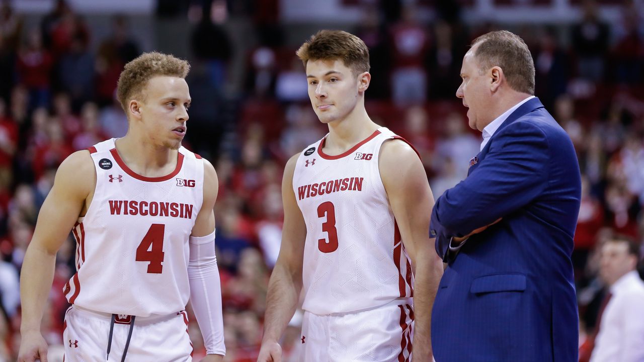 Wisconsin head coach Greg Gard talks with Carter Higginbottom (4) and Walt McGrory during the second half of an NCAA college basketball game