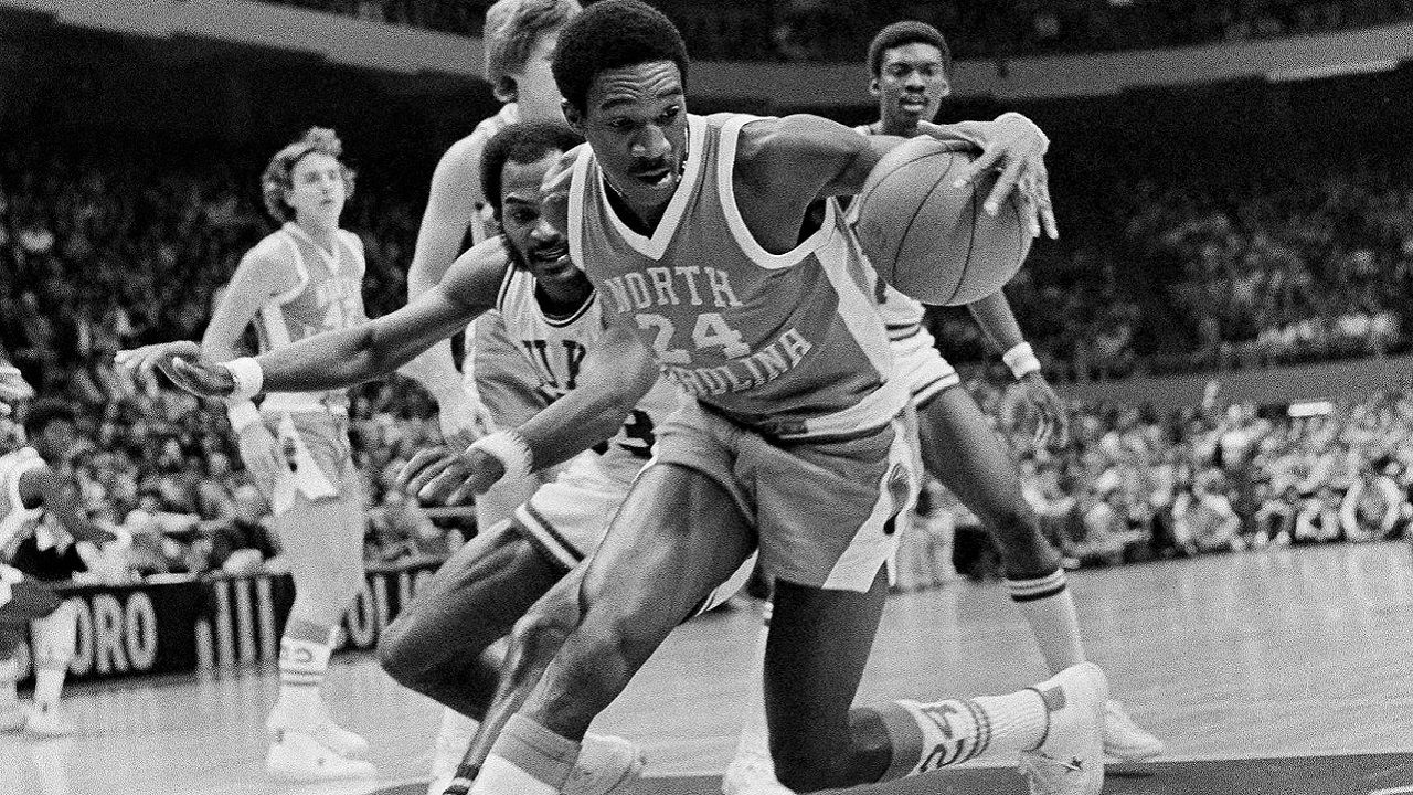 FILE - Forward Walter Davis (24) of North Carolina, grabs the ball in front of Duke's George Moses, left, during an NCAA college basketball Big Four Basketball Tournament in Greensboro, N.C., Jan. 3, 1976. Davis, a five-time NBA All-Star who had his number retired by the Phoenix Suns, has died. He was 69. Davis was star in college for North Carolina where he played for the late Dean Smith. The school's release said Walter Davis died Thursday morning, Nov. 2, 2023, of natural causes while visiting family in Charlotte, North Carolina. (AP Photo/Harold Valentine, File)