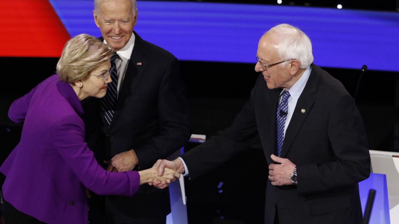 Elizabeth Warren and Bernie Sanders shake hands during an at times tense Democratic debate, taking place in Des Moines, Iowa less than a month before the state's caucuses. (Associated Press)