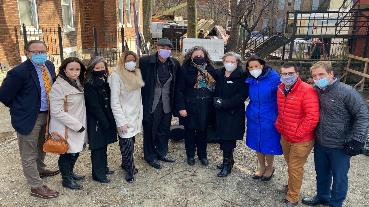 Project partners pose for a picture during the groundbreaking for the Warsaw Avenue Creative Campus. (Spectrum News 1/Casey Weldon)