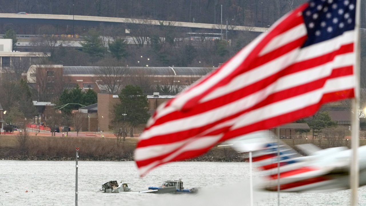 Search efforts are seen around a wreckage site of a deadly midair collision between an American Airlines jet and an Army helicopter, in the Potomac River near Ronald Reagan Washington National Airport, Friday, Jan. 31, 2025, in Arlington, Va., as an American Airlines jet lifts off from the airport. (AP Photo/Alex Brandon)