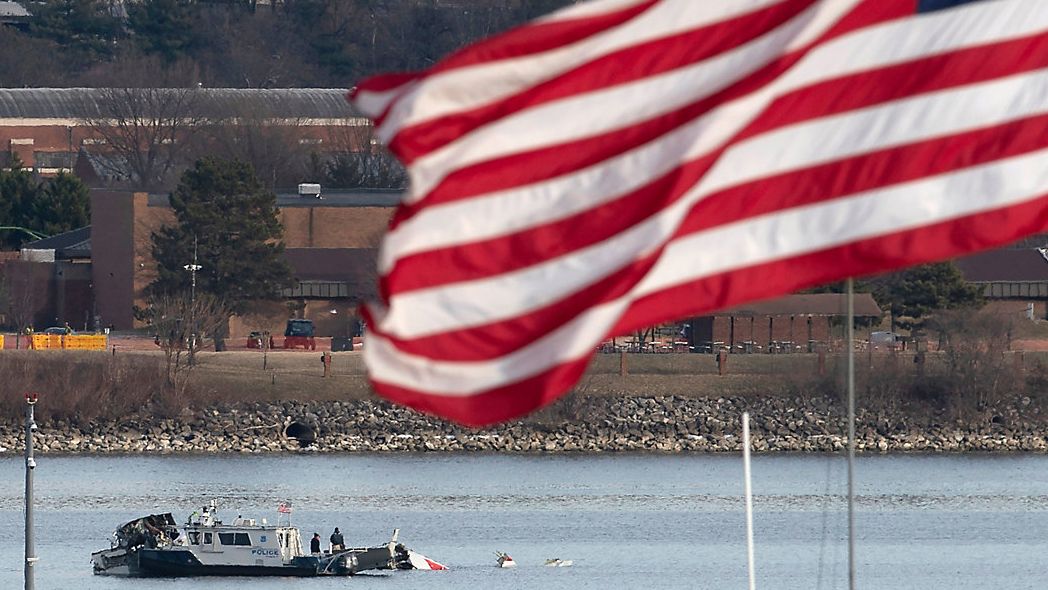 A police boat is seen around a wreckage site in the Potomac River from Ronald Reagan Washington National Airport, Thursday, Jan. 30, 2025, in Arlington, Va. (AP Photo/Jose Luis Magana)