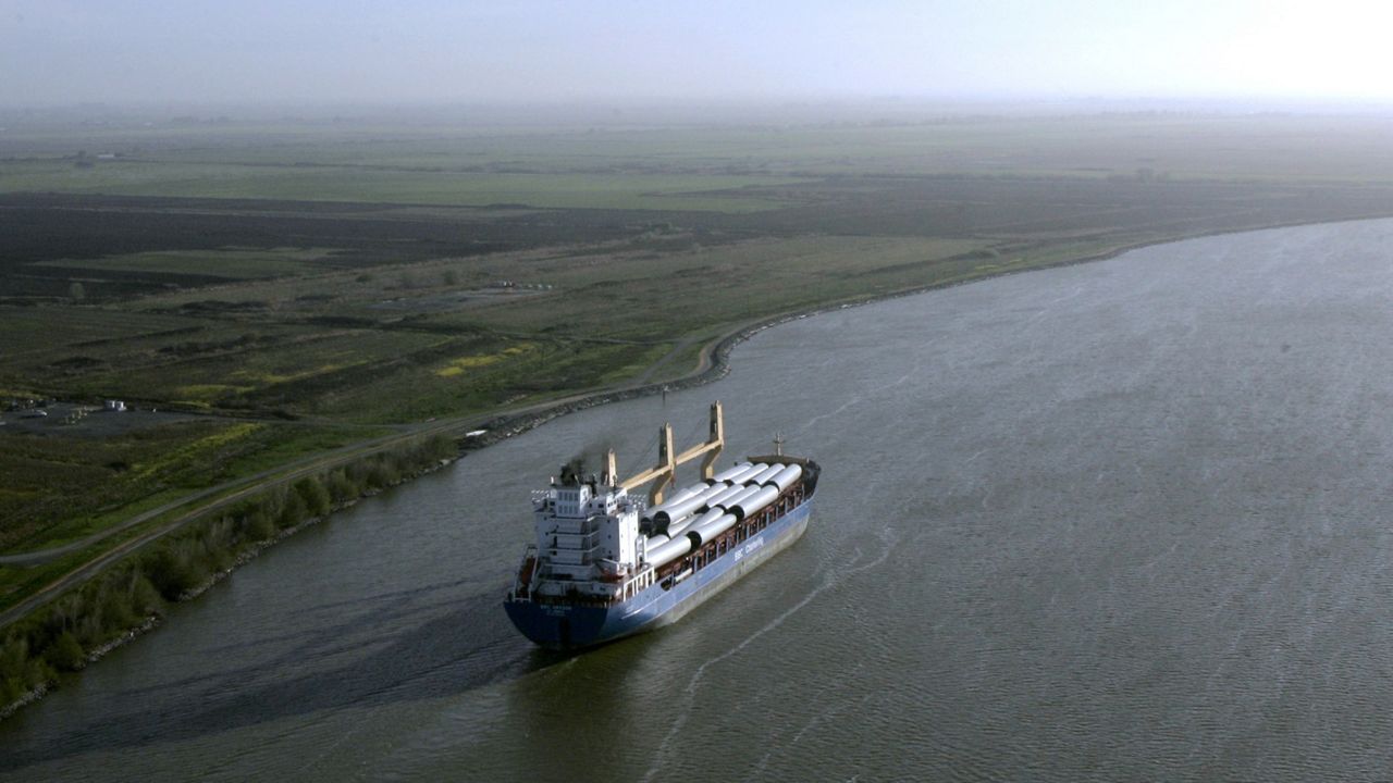 A ship moves through the Sacramento-San Joaquin River Delta near Bethel Island, Calif., March 12, 2008. California Gov. Gavin Newsom's administration now says it will cost more than $20 billion to build a giant tunnel so the state can catch more water when it rains and store it to better prepare for longer droughts caused by climate change. (AP Photo/Rich Pedroncelli)