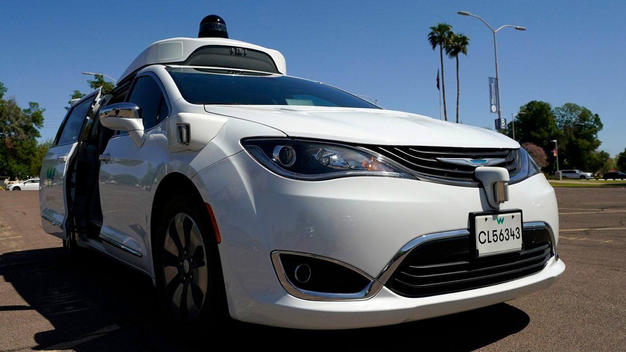 A Waymo minivan arrives to pick up passengers for an autonomous vehicle ride. (AP Photo/Ross D. Franklin)