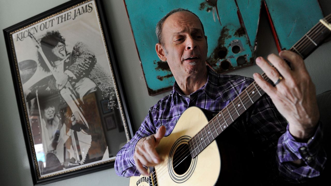 Guitarist Wayne Kramer plays an instrument at his recording studio in Los Angeles on Jan. 16, 2012.