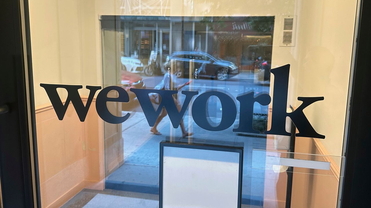 A sign for WeWork is displayed at the workspace-sharing office in Manhattan on Aug. 9, 2023.