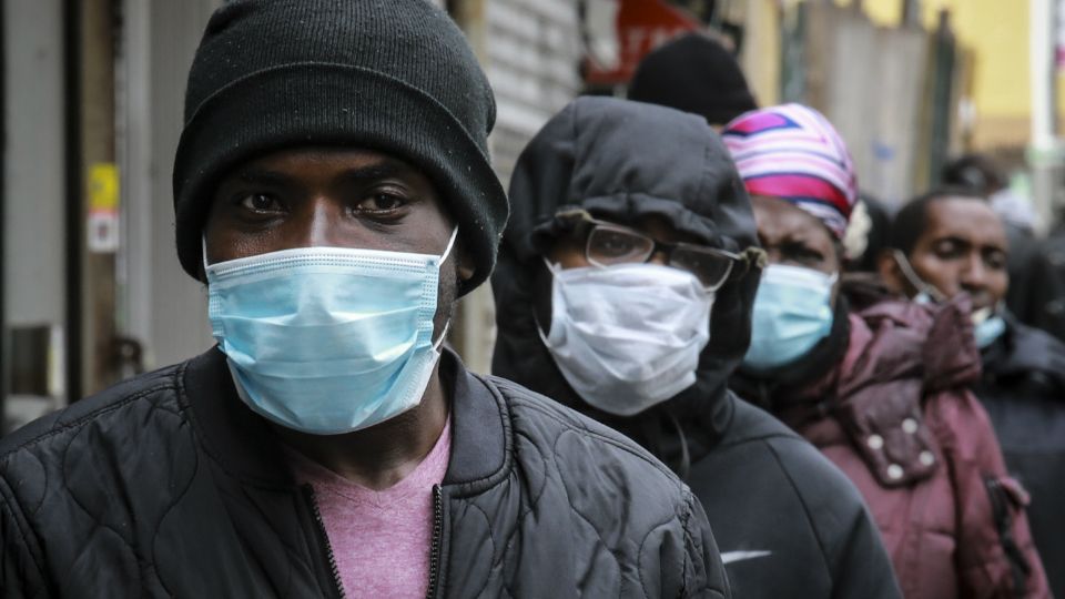 People wait for a distribution of masks and food from the Rev. Al Sharpton in the Harlem neighborhood of New York, after a new state mandate was issued requiring residents to wear face coverings in public due to the COVID-19 coronavirus, Saturday, April 18, 2020. 