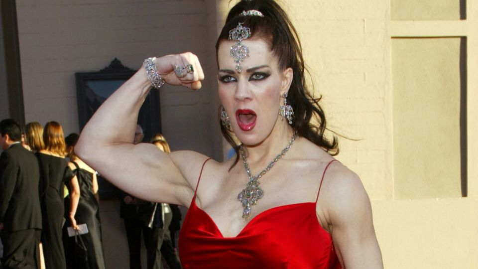 FILE - In this Nov. 16, 2003, file photo, Joanie Laurer, former pro wrestler known as Chyna, flexes her bicep as she arrives at the 31st annual American Music Awards, in Los Angeles. Chyna, the WWE star who became one of the best known and most popular female professional wrestlers in history in the late 1990s, has died at age 46. Los Angeles County coroner’s Lt. Larry Dietz said Chyna was found dead in Redondo Beach on Wednesday, April 20, 2016. 