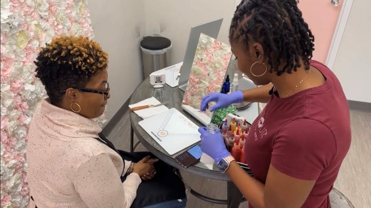 Diamond Weems provides customer service at her business, Lip N Pour.