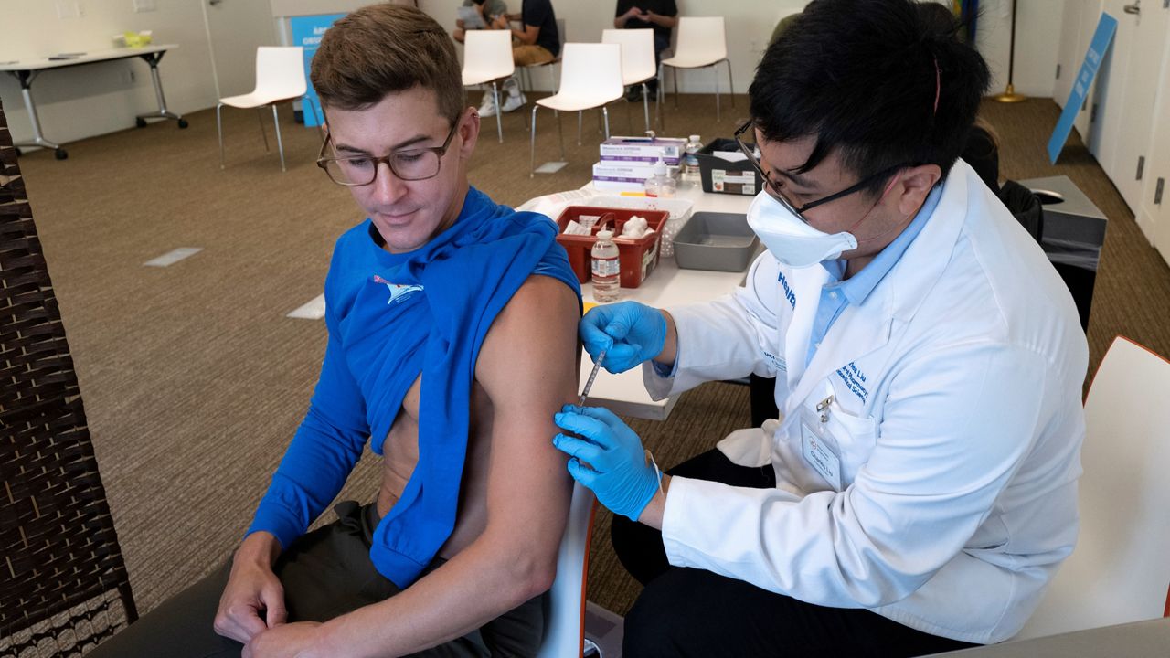 Scott Marszalek receives a Monkeypox vaccination at a Pop-Up Monkeypox vaccination site at the West Hollywood Library Community Meeting Room on Wednesday, Aug. 3, 2022, in West Hollywood, Calif. (AP Photo/Richard Vogel)
