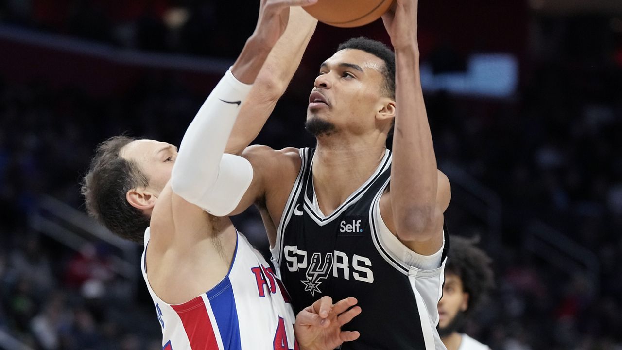 San Antonio Spurs center Victor Wembanyama (1) is defended by Detroit Pistons forward Bojan Bogdanovic (44) during the first half of an NBA basketball game, Wednesday, Jan. 10, 2024, in Detroit. (AP Photo/Carlos Osorio)