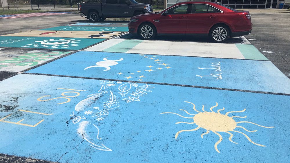 Some of the student-painted parking spaces at West Shore Junior/Senior High School in Melbourne. Students are raising money for the senior class trip. (Jerry Hume, Spectrum News)