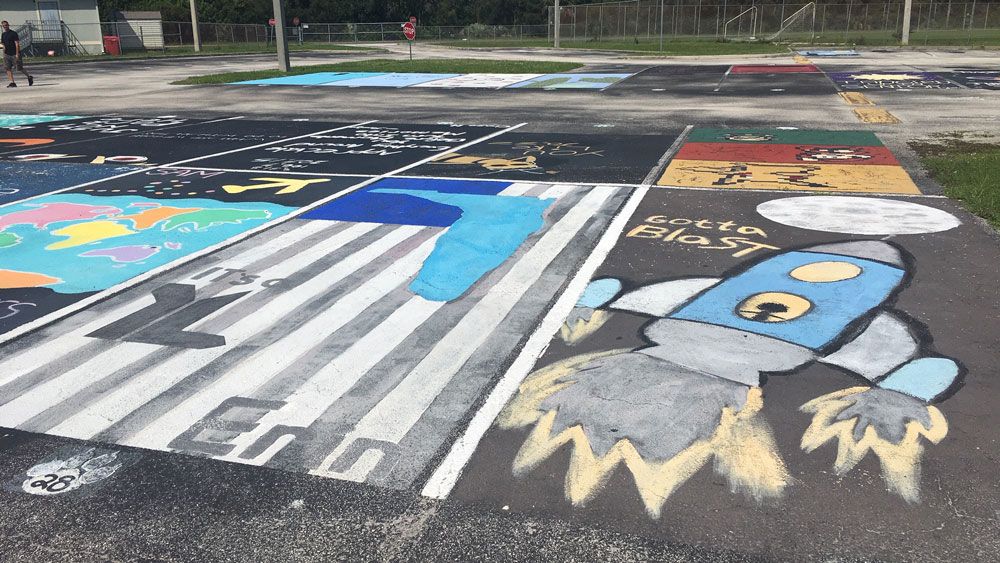 Some of the student-painted parking spaces at West Shore Junior/Senior High School in Melbourne. Students are raising money for the senior class trip. (Jerry Hume, Spectrum News)