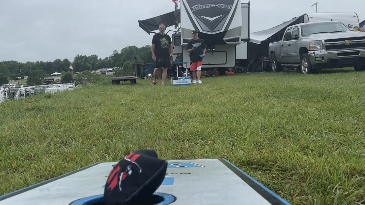 Mike Westfall plays cornhole with friends at the campground. (Spectrum News 1)
