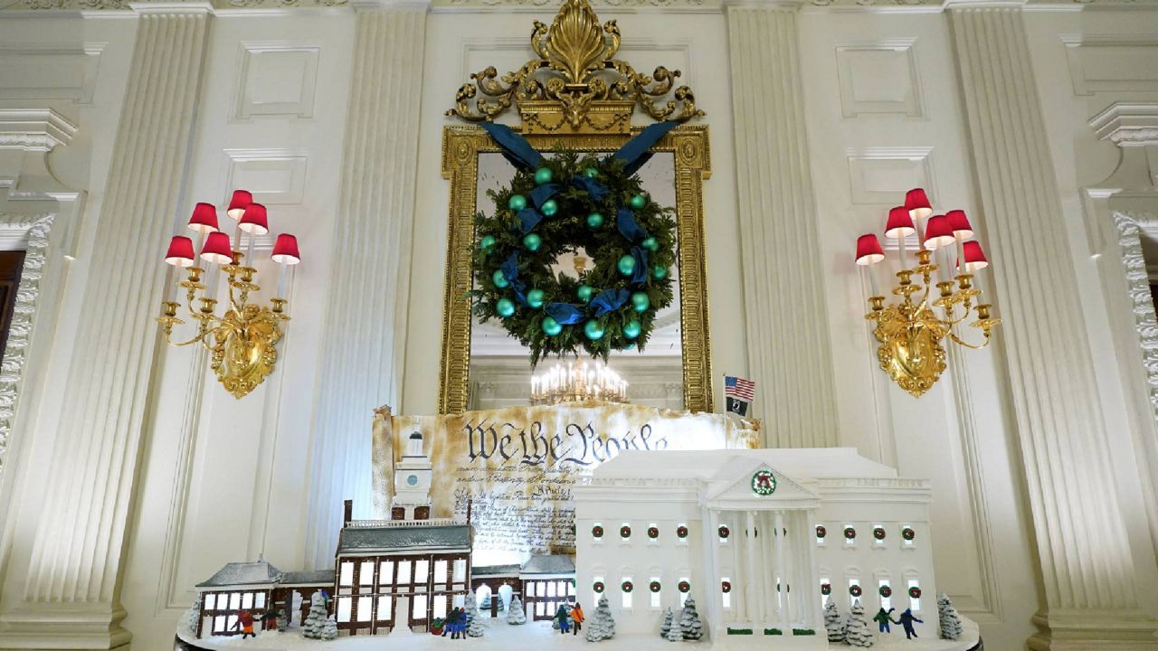 A sugar cookie replica of Independence Hall and a gingerbread replica of the White House are on display in the State Dining Room of the White House during a press preview of holiday decorations at the White House, Monday, Nov. 28, 2022, in Washington. (AP Photo/Patrick Semansky)