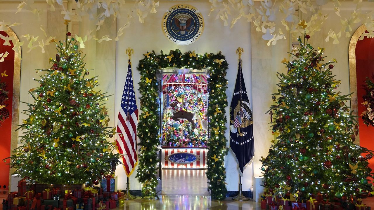 Trees in the Cross Hall frame the doorway to the Blue Room of the White House in Washington, as everything is decorated for the holidays, Monday, Dec. 2, 2024. (AP Photo/Susan Walsh)