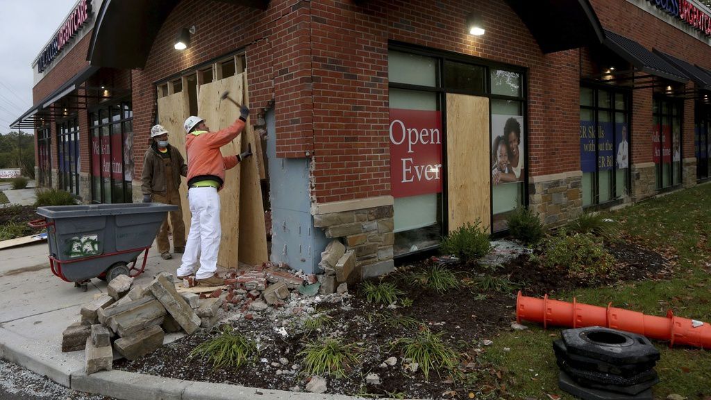 Louis Kloeppel, with Interface Construction, demolishes part of a damaged wall so repairs can begin on Monday, Oct. 19, 2020, at the Total Access Urgent Care in Chesterfield, Mo.(Laurie Skrivan/St. Louis Post-Dispatch via AP)