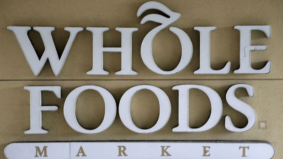 In this Aug. 28, 2018 file photo, a sign at a Whole Foods Market greets shoppers in Tampa, Fla. (AP Photo/Chris O'Meara)