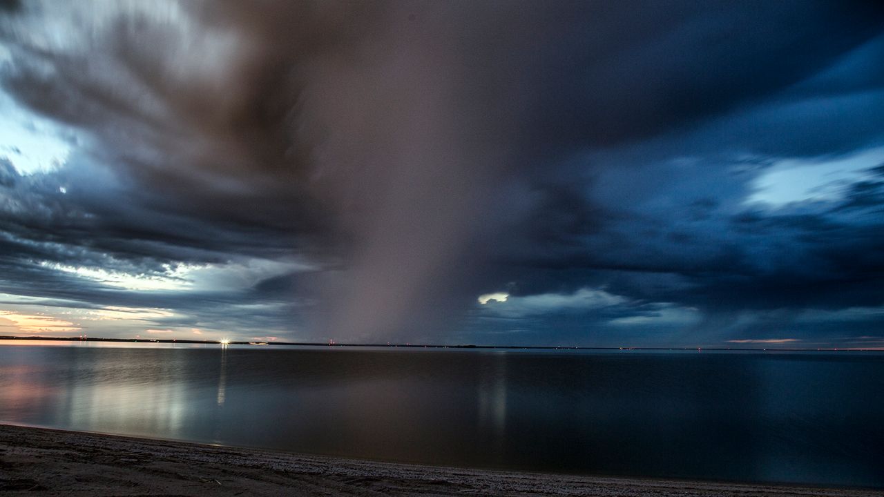 The rain storm on the bay of Green Bay was swirling in a narrow band like a tornado.