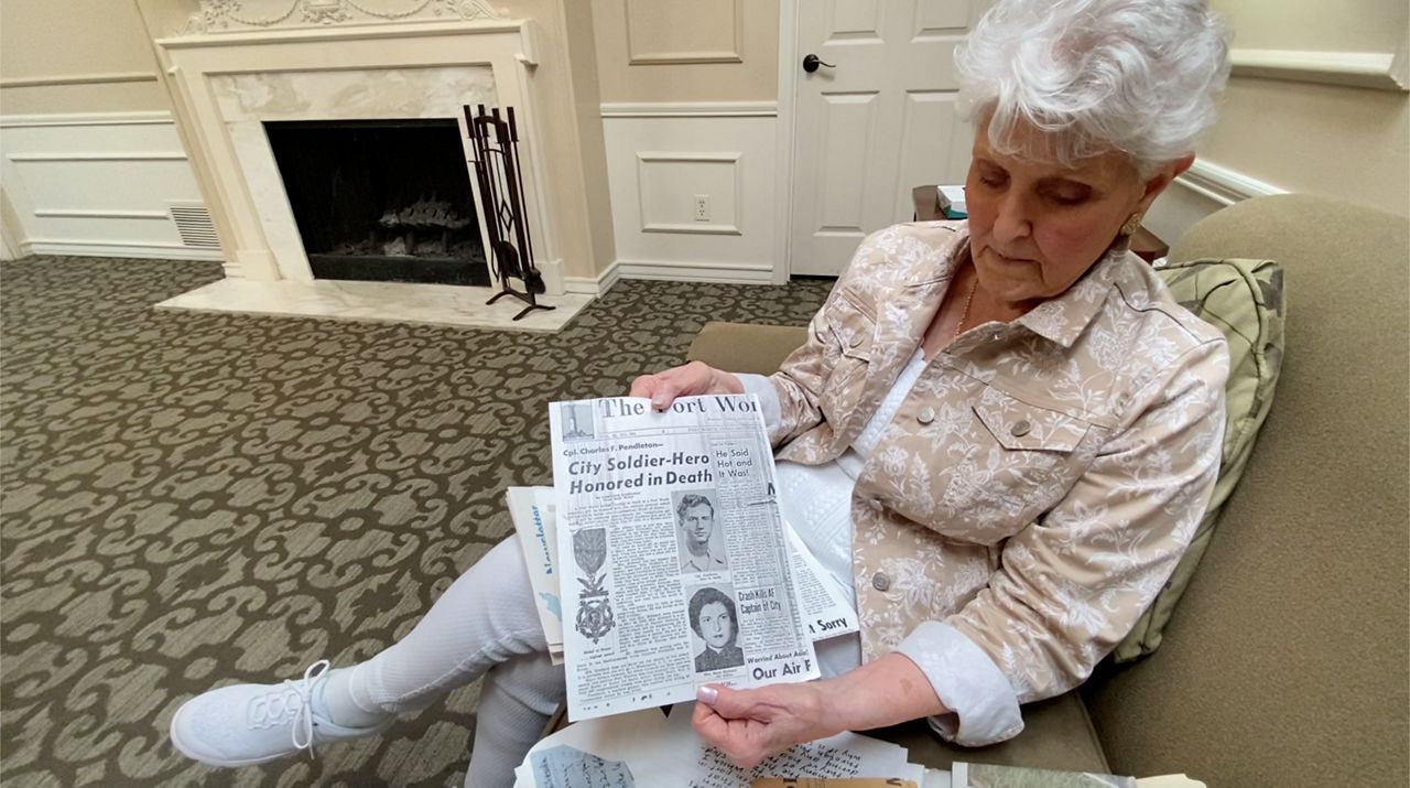 Mary Margaret Snell shares newspaper clippings concerning her late husband, Cpl. Charles Frank Pendleton. (Spectrum News 1/Magaly Ayala)
