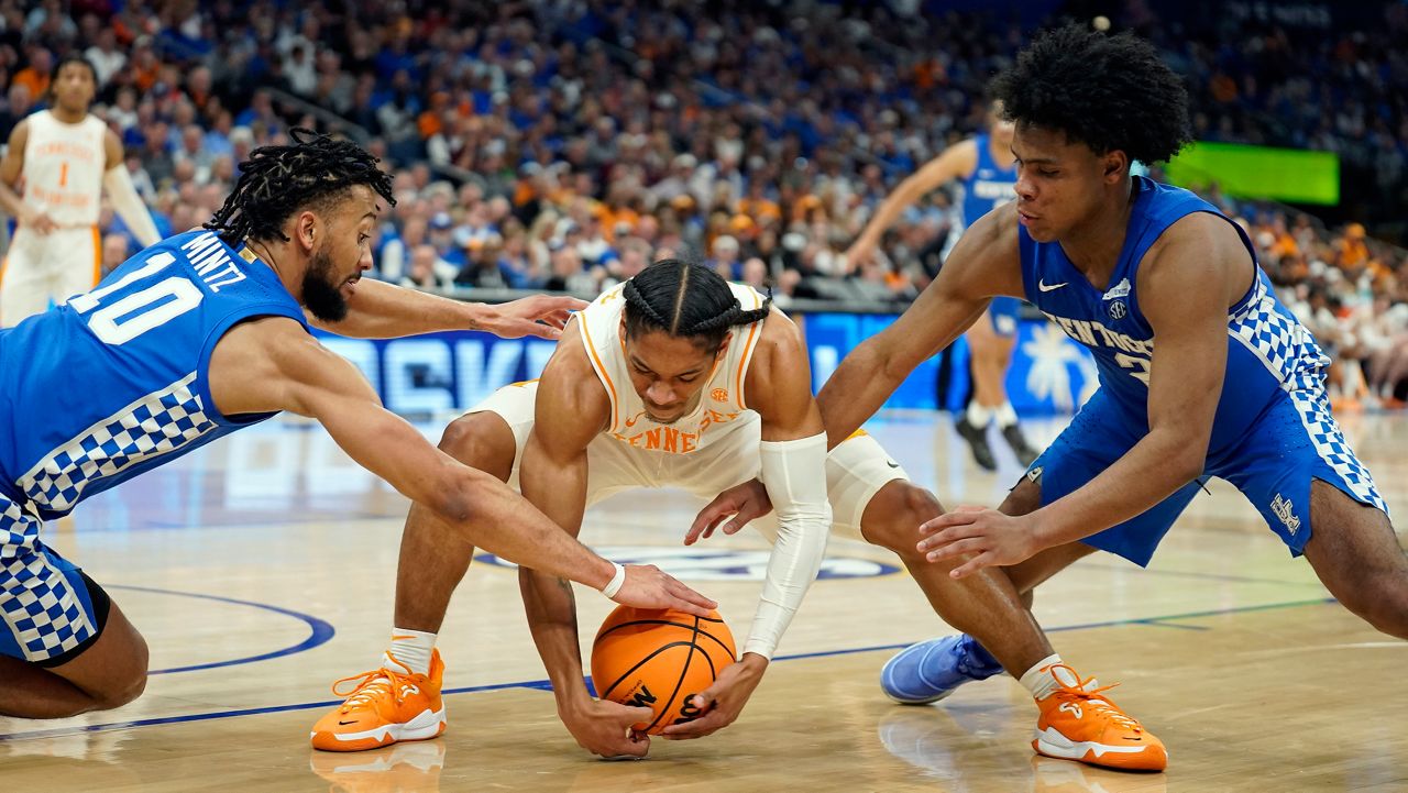 Tennessee guard Zakai Zeigler is double teamed by Kentucky guards Davion Mintz (10) and Sahvir Wheeler (2) during the second half of an NCAA college basketball game in the semifinal round at the Southeastern Conference tournament, Saturday, March 12, 2022, in Tampa, Fla. (AP Photo/Chris O'Meara)