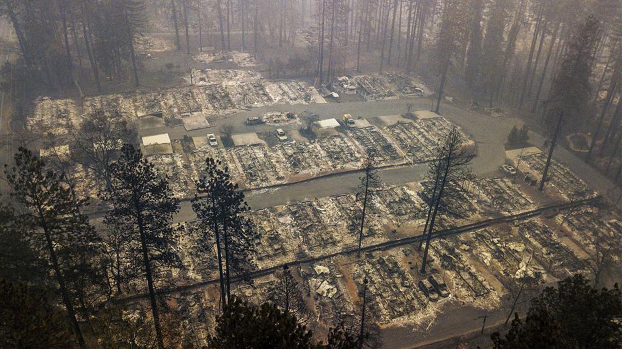 In this Thursday, Nov. 15, 2018, file photo, residences leveled by the Camp Fire line a neighborhood in Paradise, Calif. (AP Photo/Noah Berger, File)