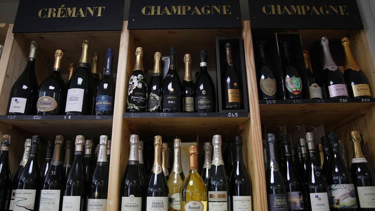 Bottles of Champagne are for sale at a wine dealer shop as President Donald Trump threatened a 200% tariff on European wine, Champagne and spirits if the European Union goes forward with a planned tariff on American whiskey, Thursday, March 13, 2025 in Ville d'Avray, outside Paris. (AP Photo/Christophe Ena)