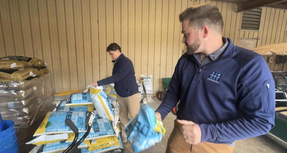 Glenda Bebber, far left, is the associate vice president of campus operations for Wingate University. Bebber and director of grounds Blake Center are prepping ice melt ahead of the expected winter storm. (Spectrum News 1/Jennifer Roberts)