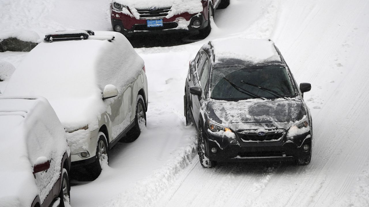 A motorist struggles to move along Pearl Street as a winter storm sweeps over the intermountain West, plunging temperatures into the single digits and bringing along a light snow in its wake Saturday, Jan. 18, 2025, in Denver. (AP Photo/David Zalubowski)