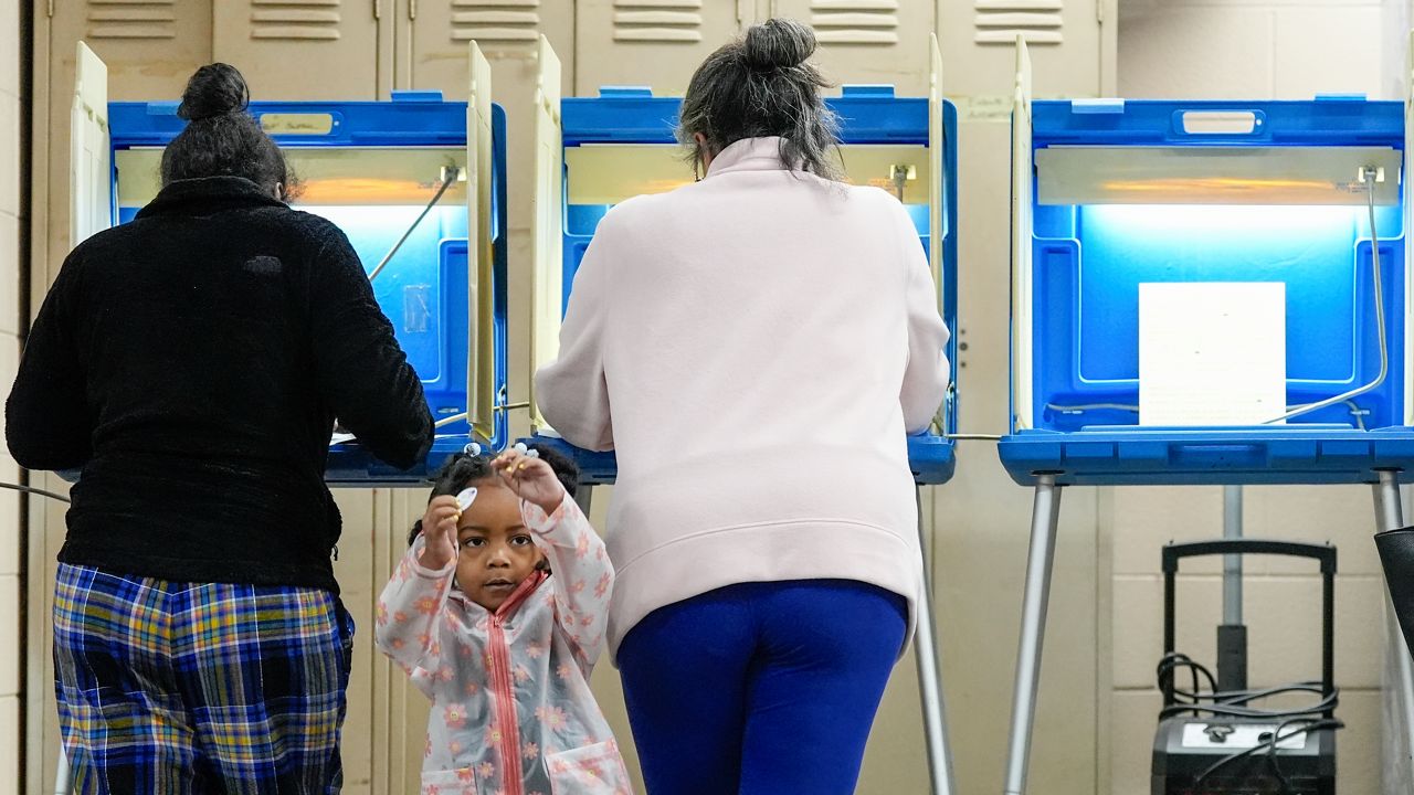 Three-year old- K-Lee waits as her mother Heather Ramsey votes during the Spring election Tuesday, April 2, 2024