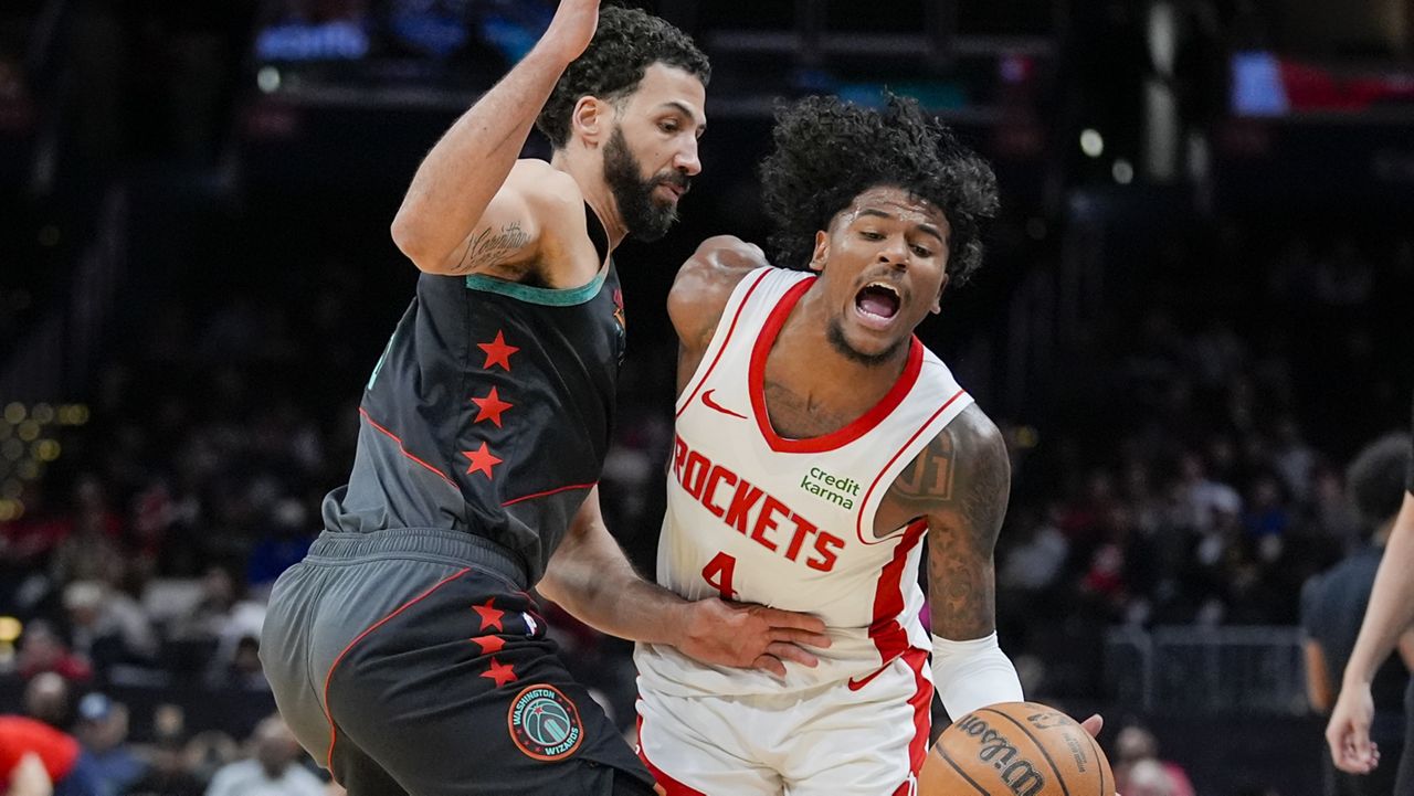 Washington Wizards forward Anthony Gill, left, fouls Houston Rockets guard Jalen Green during the first half of an NBA basketball game Tuesday, March 19, 2024, in Washington. (AP Photo/Alex Brandon)