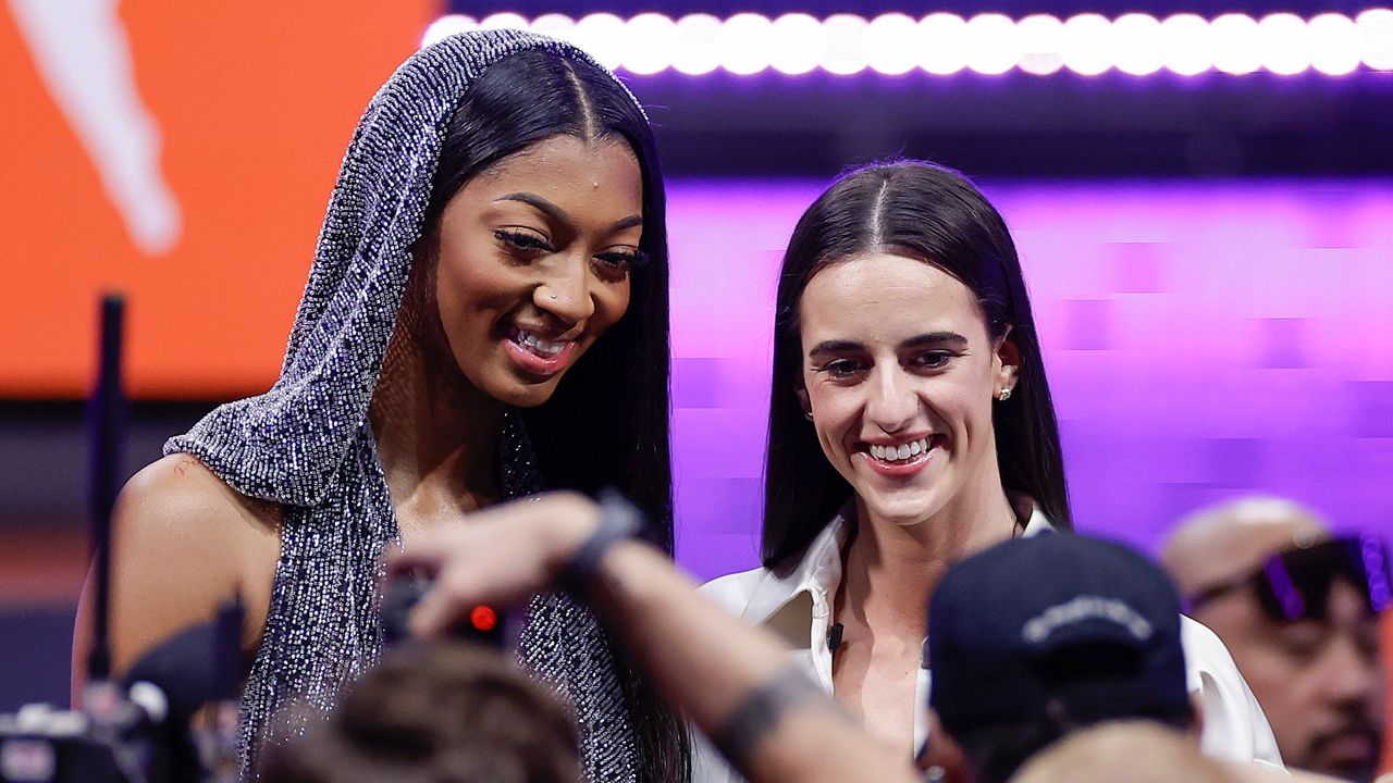 LSU's Angel Reese, left, and Iowa's Caitlin Clark, right, pose for a photo before the WNBA basketball draft, April 15, 2024, in New York. (AP Photo/Adam Hunger, File)