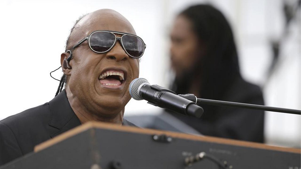 In this Sunday, Nov. 6, 2016 file photo, Musician Stevie Wonder performs at a campaign rally for Democratic presidential candidate Hillary Clinton before President Barack Obama spoke to the audience in Kissimmee, Fla. (AP Photo/John Raoux, File)