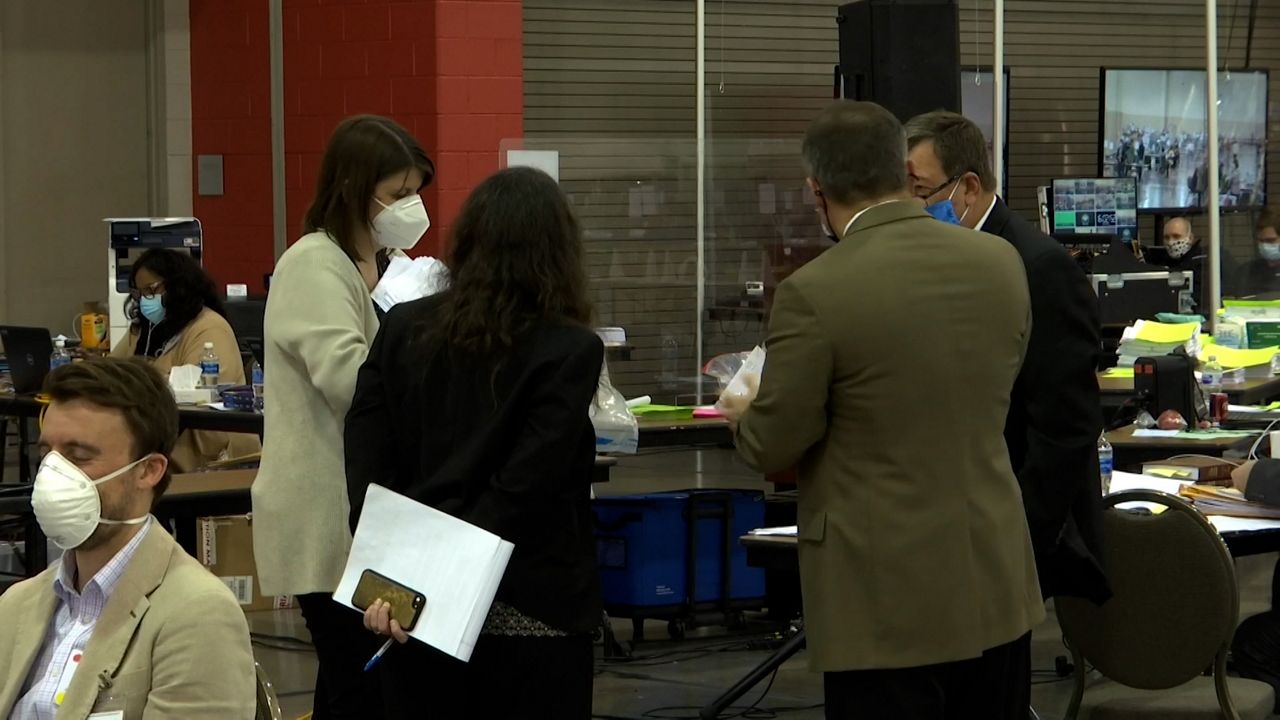 Claire Woodall-Vogg (standing, far left), the top election official in Milwaukee, Wisconsin, has received multiple threats in the wake of the 2020 election. (Spectrum News)