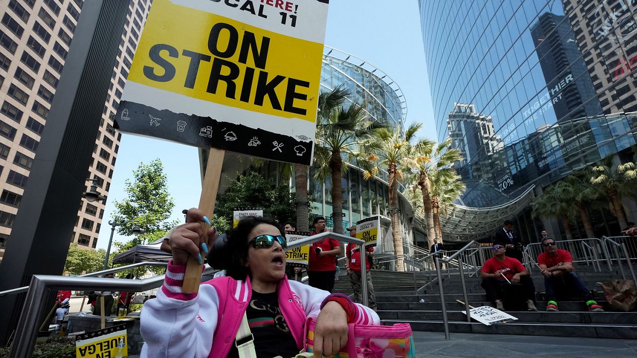Striking hotel worker Tayra Dehart joins a rally outside the Intercontinental Hotel on Monday, July 3, 2023, in downtown Los Angeles. (AP Photo/Damian Dovarganes)