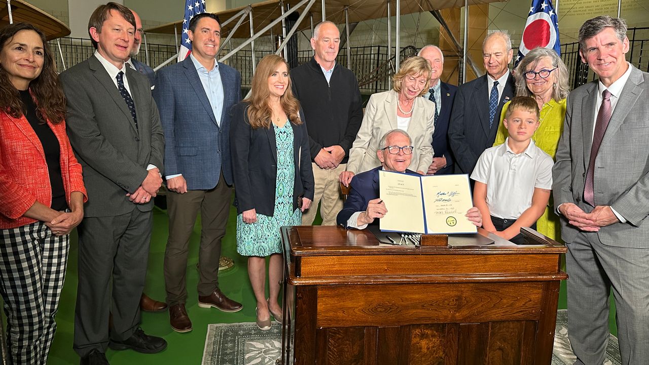 Governor Mike DeWine, state Senators Terry Johnson and Steve Huffman, and the staff at Carillon Historical park came together for a ceremonial bill signing of Senate Bill 24. 