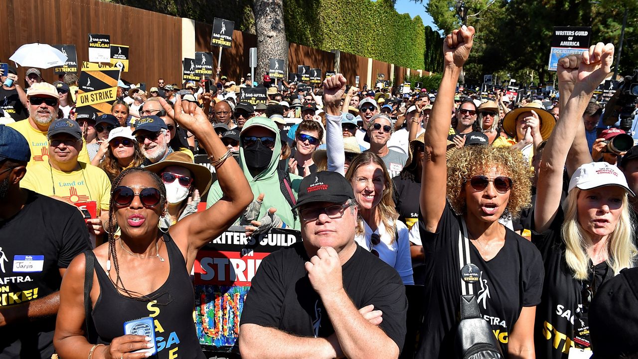 Sean Astin, center, Michelle Hurd, second right, and marchers attend the Day of Solidarity union rally on Tuesday, Aug. 22, 2023, at Disney Studios in Burbank, Calif. The event includes members of SAG-AFTRA, the WGA and the AFL-CIO. (Photo by Jordan Strauss/Invision/AP)